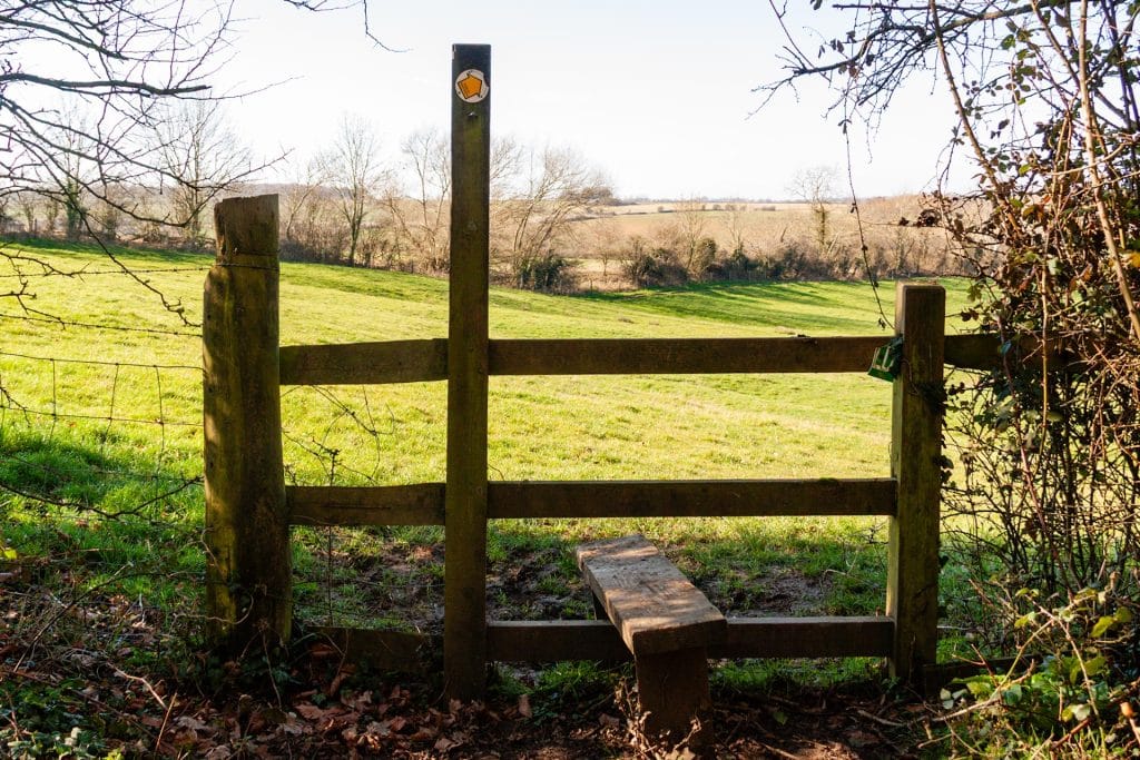 a wooden style looking out onto a sunny field